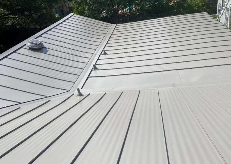 Solar attic fan installed on a metal roof for Roof Ventilation in Chubbuck