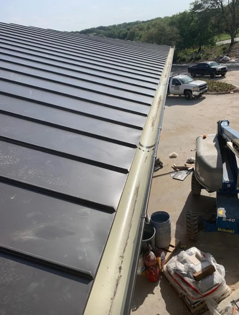 Standing seam panel and gutter detail on a metal roofing jobsite in Chubbuck